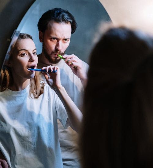 couple brushing their teeth